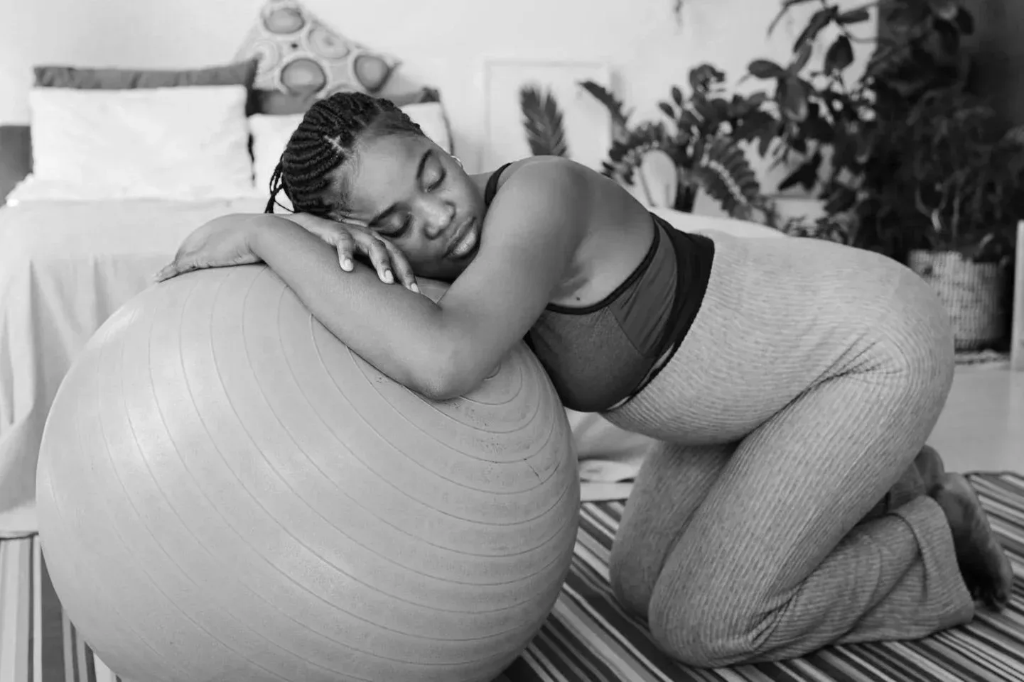 A woman resting on a birthing ball during labour